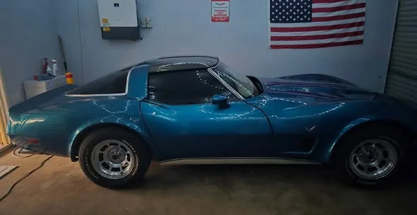 Blue C3 Corvette with tinted glass in a garage