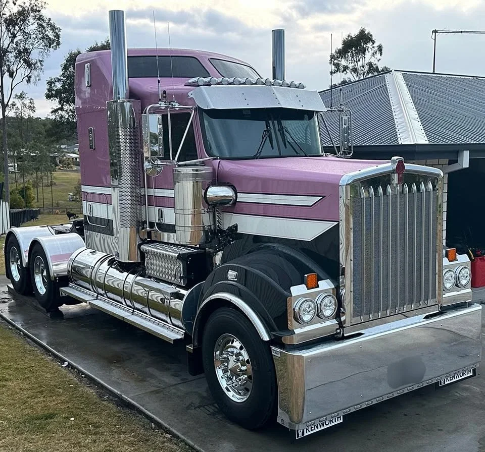 Pink Kenworth prime mover with tinted windows