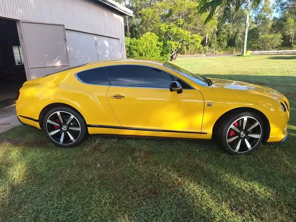 Yellow Bentley Continental GT with freshly tinted windows